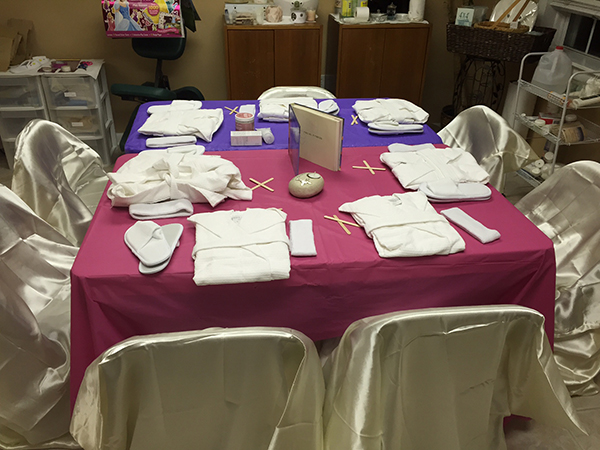 Spa party table set with robes and spa supplies