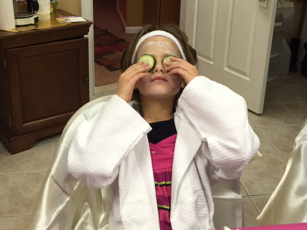 Child receiving a spa facial treatment